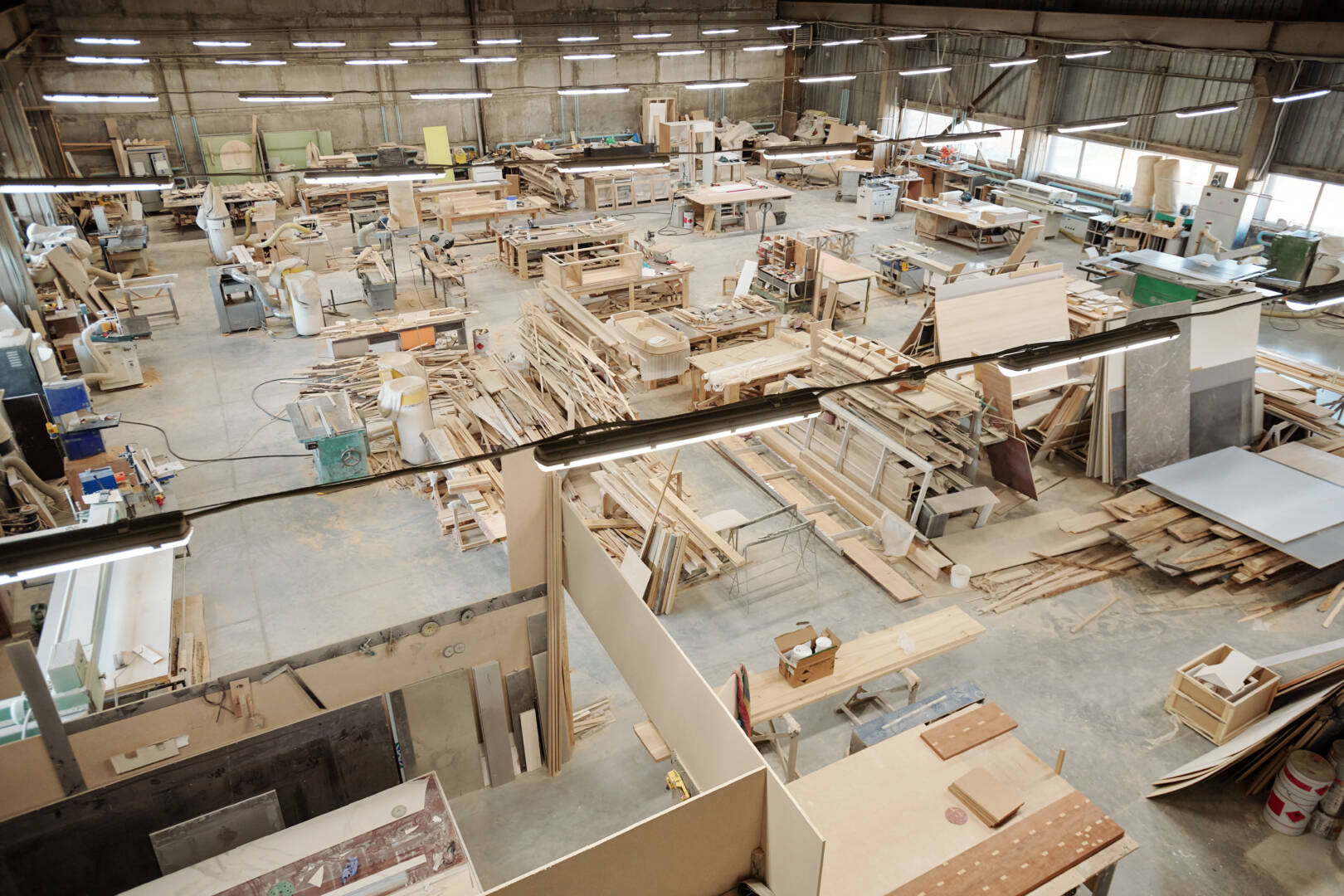 Interior of large workshop of contemporary furniture factory with workplaces